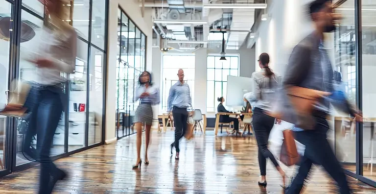 blurry people walking in office